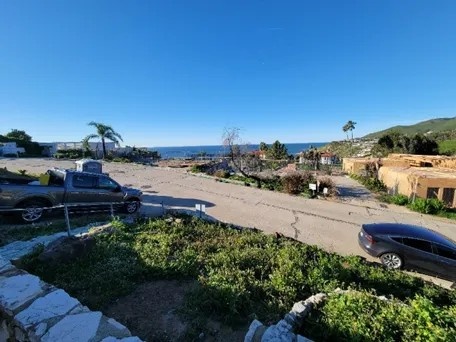 A picture Jeanine took of the destruction surrounding a home after the Palisades fire. Insurers refused to pay for proper testing and remediation, despite their home being filled with toxins.